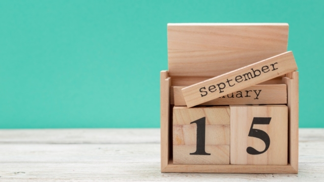 wooden cube shape calendar for september 15 on wooden tabletop